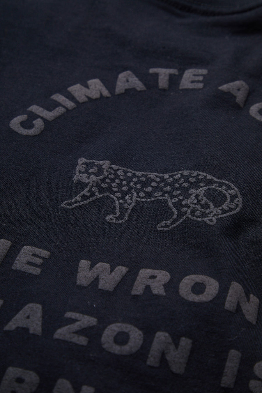 Dark blue shirt with white text and a leopard graphic on a dark background