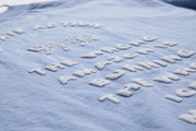 Blue fabric with white text and logo