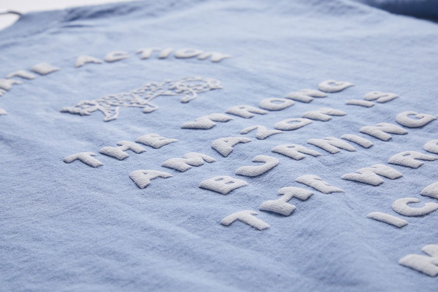 Blue fabric with white text and logo