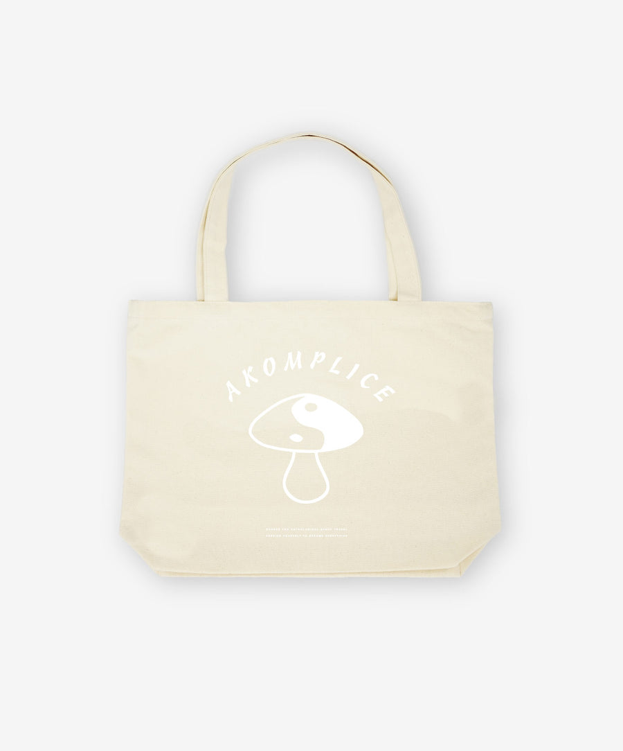 Beige tote bag with a logo and text on a white background