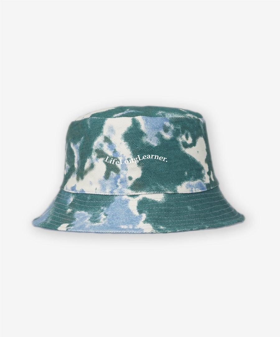 Tie-dye bucket hat with 'Life Long Learner' text on a white background