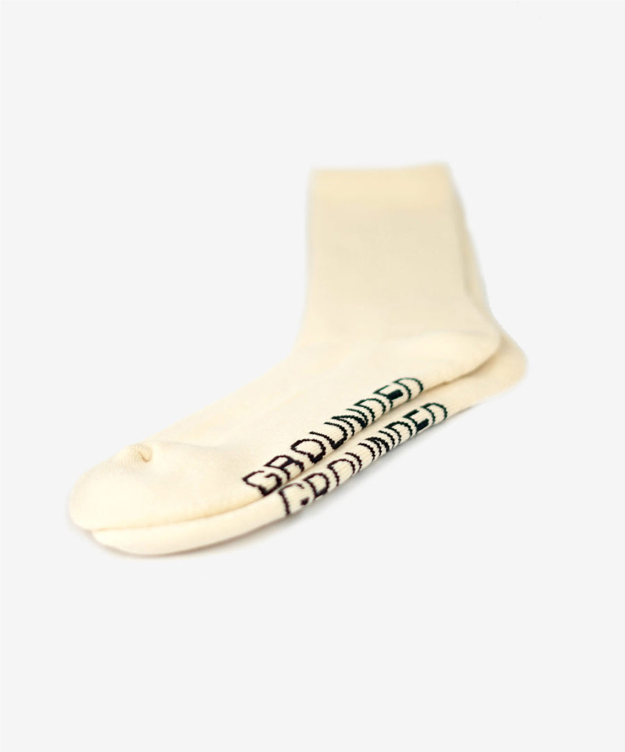 Beige sock with black text on a white background