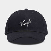 Black cap with 'Tranquilo' embroidery on a light gray background
