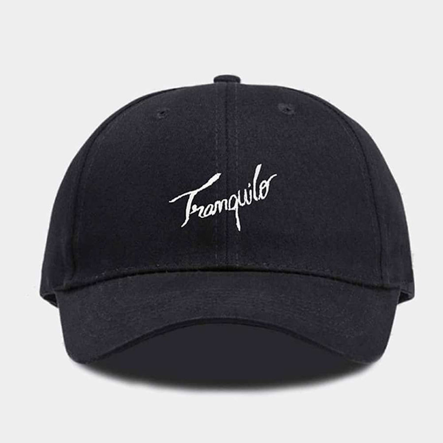 Black cap with 'Tranquilo' embroidery on a light gray background