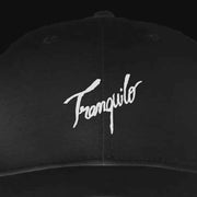 Black cap with 'Tranquilo' embroidered in white on a black background