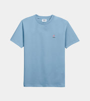 Light blue t-shirt with a small red and white graphic on a light gray background
