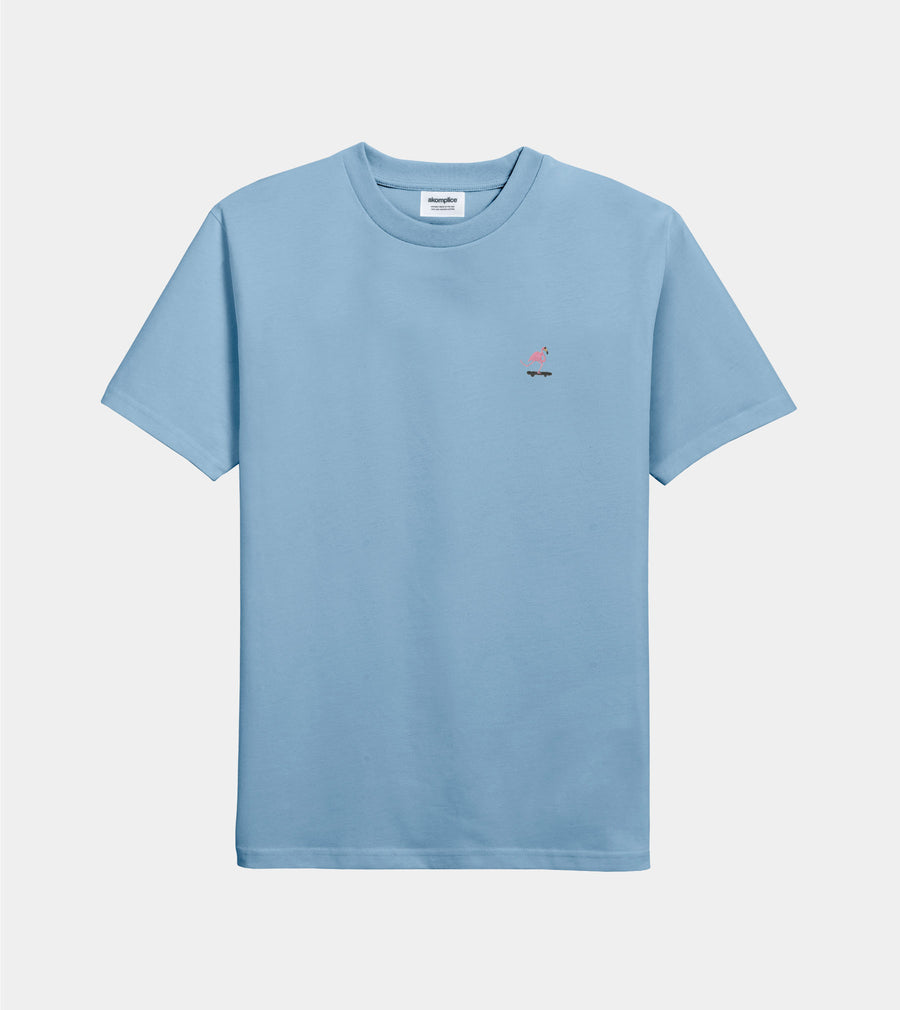 Light blue t-shirt with a small red and white graphic on a light gray background