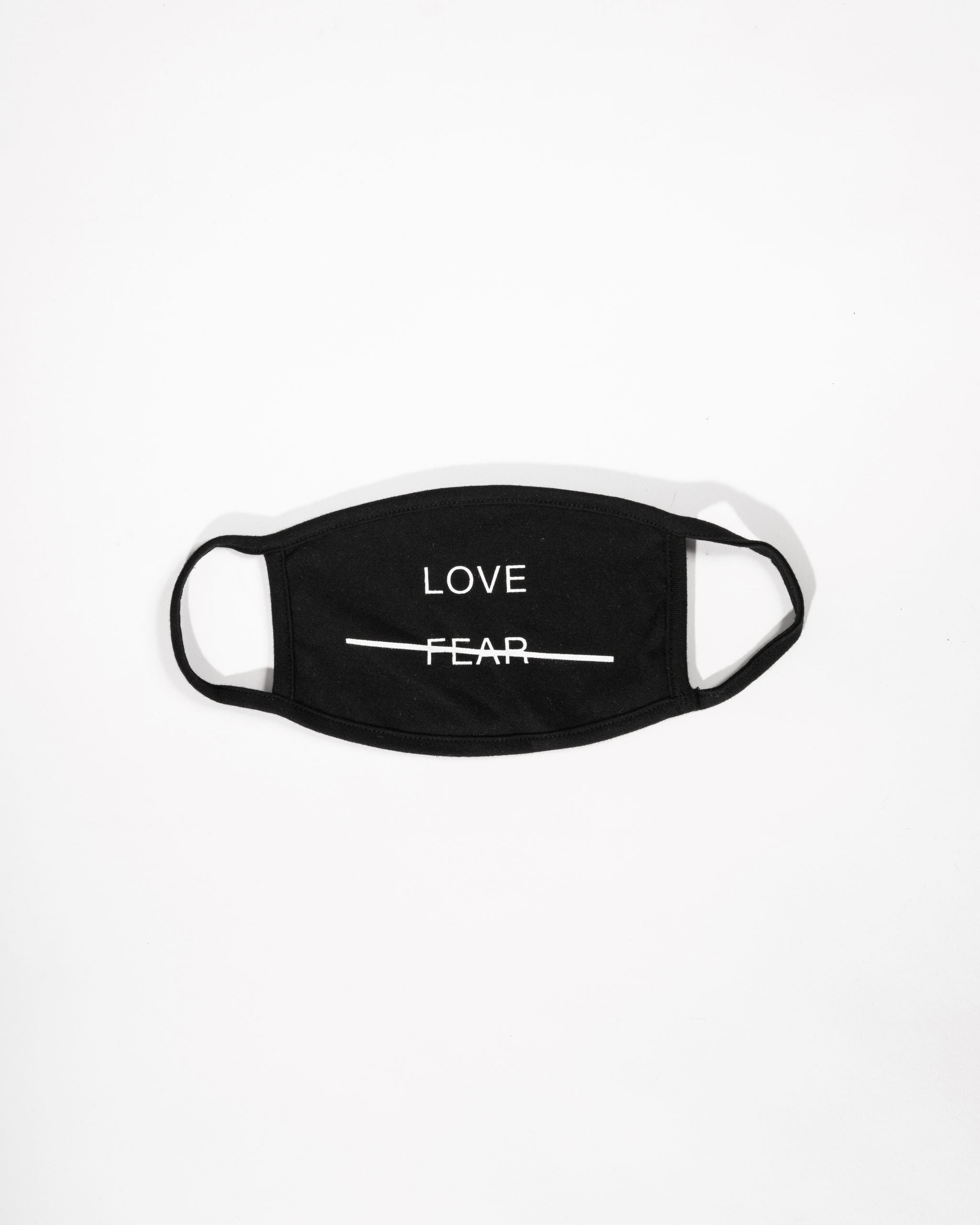 Black face mask with 'LOVE FEAR' text on a white background