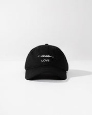 Black cap with 'FEAR LOVE' text on a white background