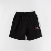Black shorts with a small logo on a white background