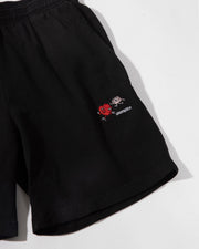 Black shorts with a small embroidered logo on a white background