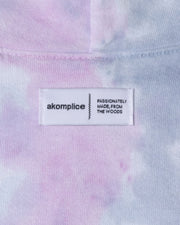 Close-up of a tie-dye fabric with an 'akomplice' label.