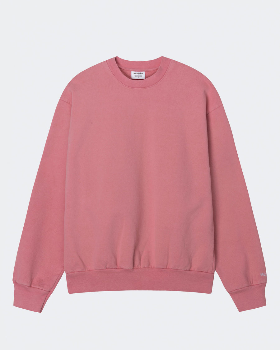 Pink sweatshirt on a light gray background