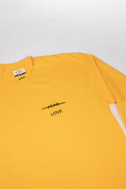 Yellow t-shirt with 'FEAR LOVE' text on a light gray background