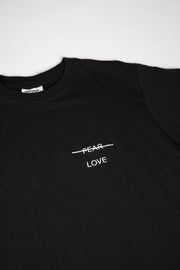 Black t-shirt with 'FEAR LOVE' text on a white background