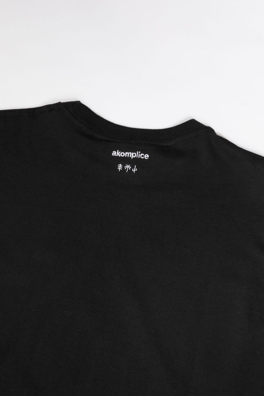 Black t-shirt with a brand logo on a white background