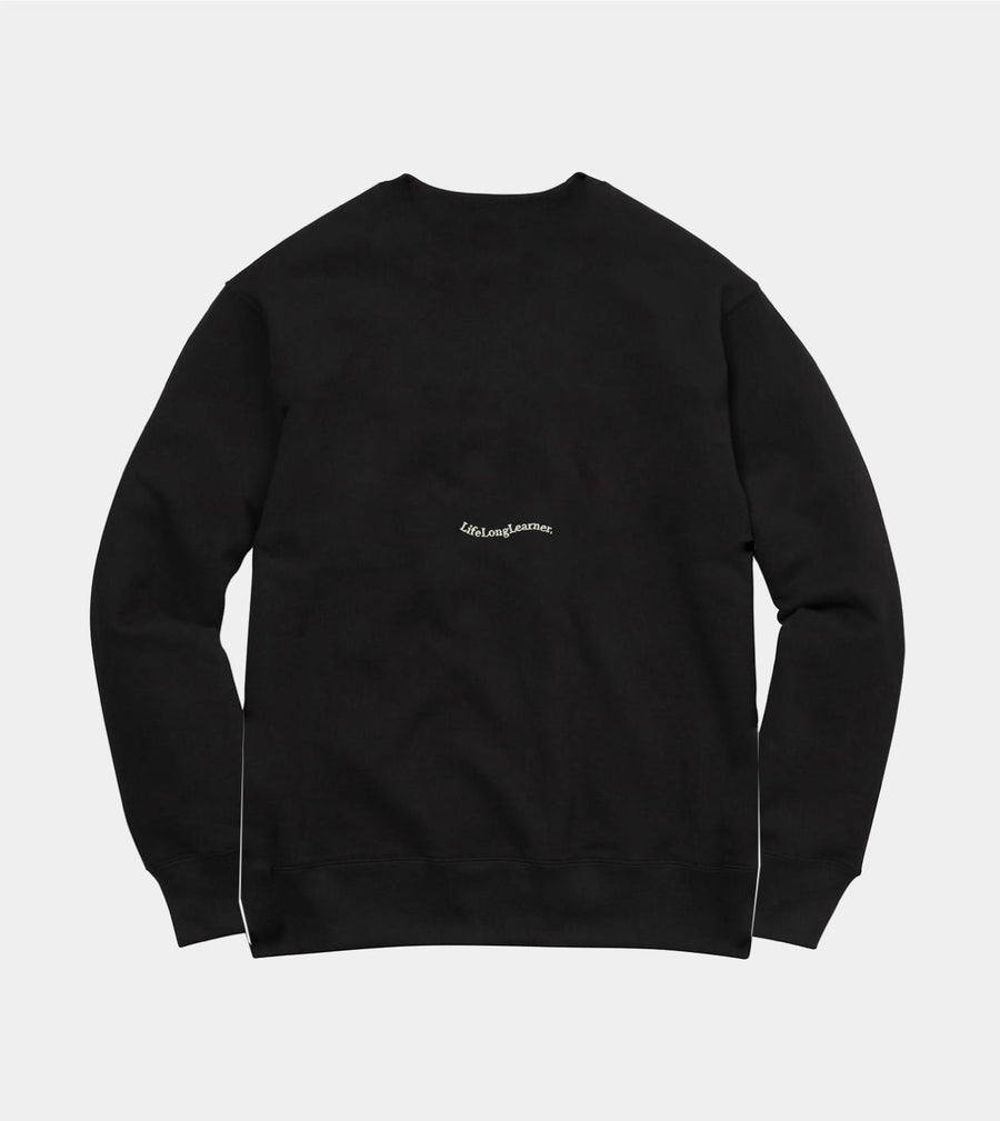 Black sweatshirt with a small logo on the chest against a light gray background