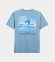 Light blue t-shirt with an underwater graphic and 'We Are Ocean' text on a light gray background