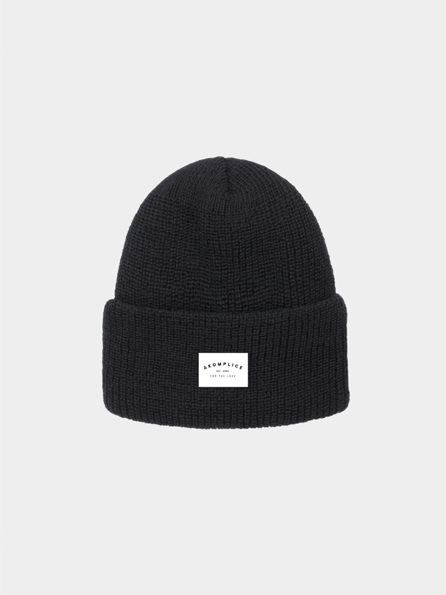 Black beanie with a white label on a light gray background