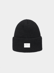 Black beanie with a white label on a light gray background