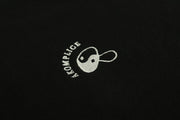 White embroidered logo on a black background