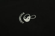 White embroidered logo on a black background