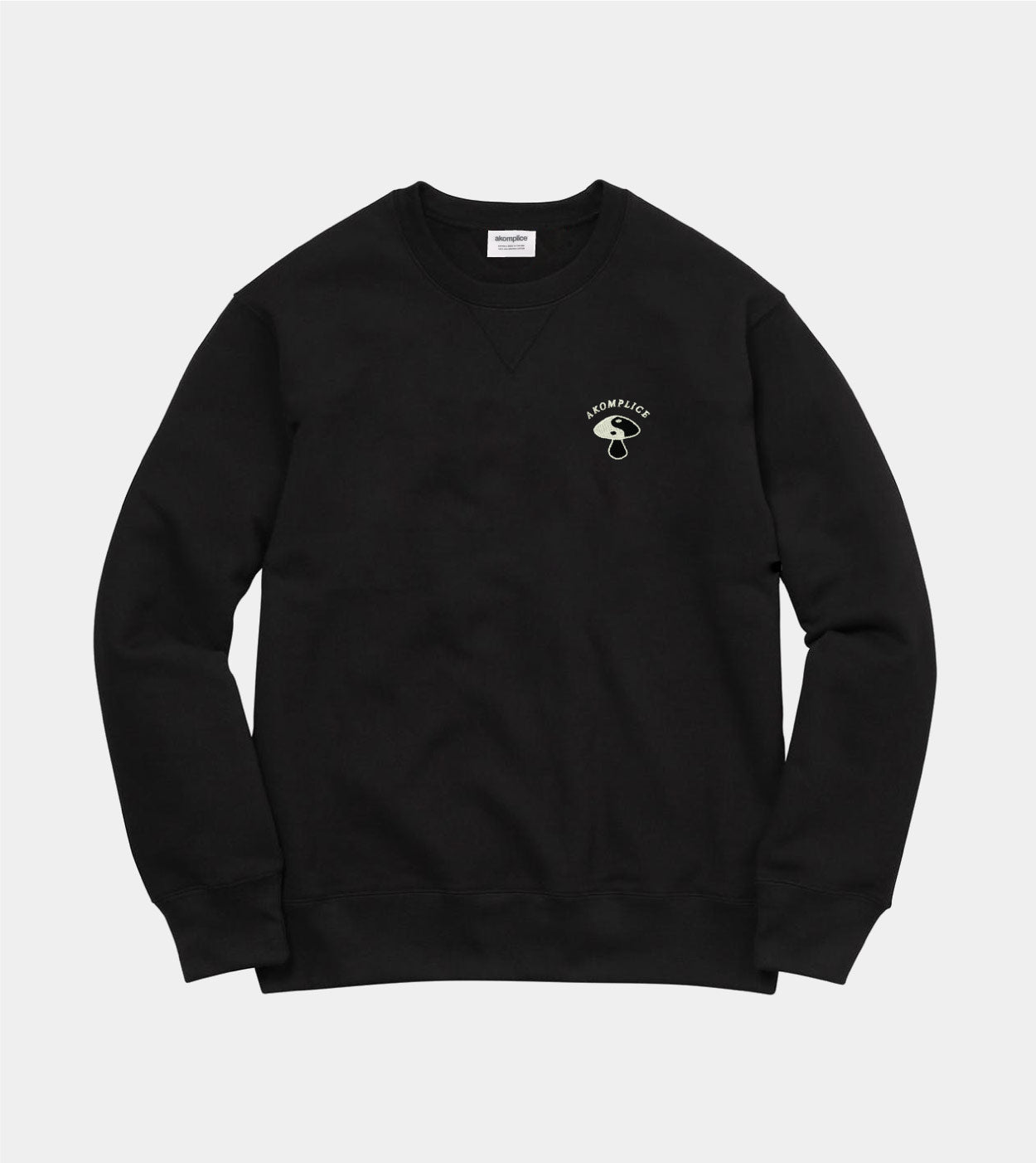 Black sweatshirt with a small white logo on a light gray background