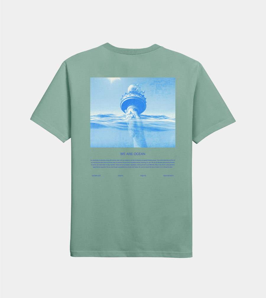 Green t-shirt with a graphic of a ship in the ocean on a white background