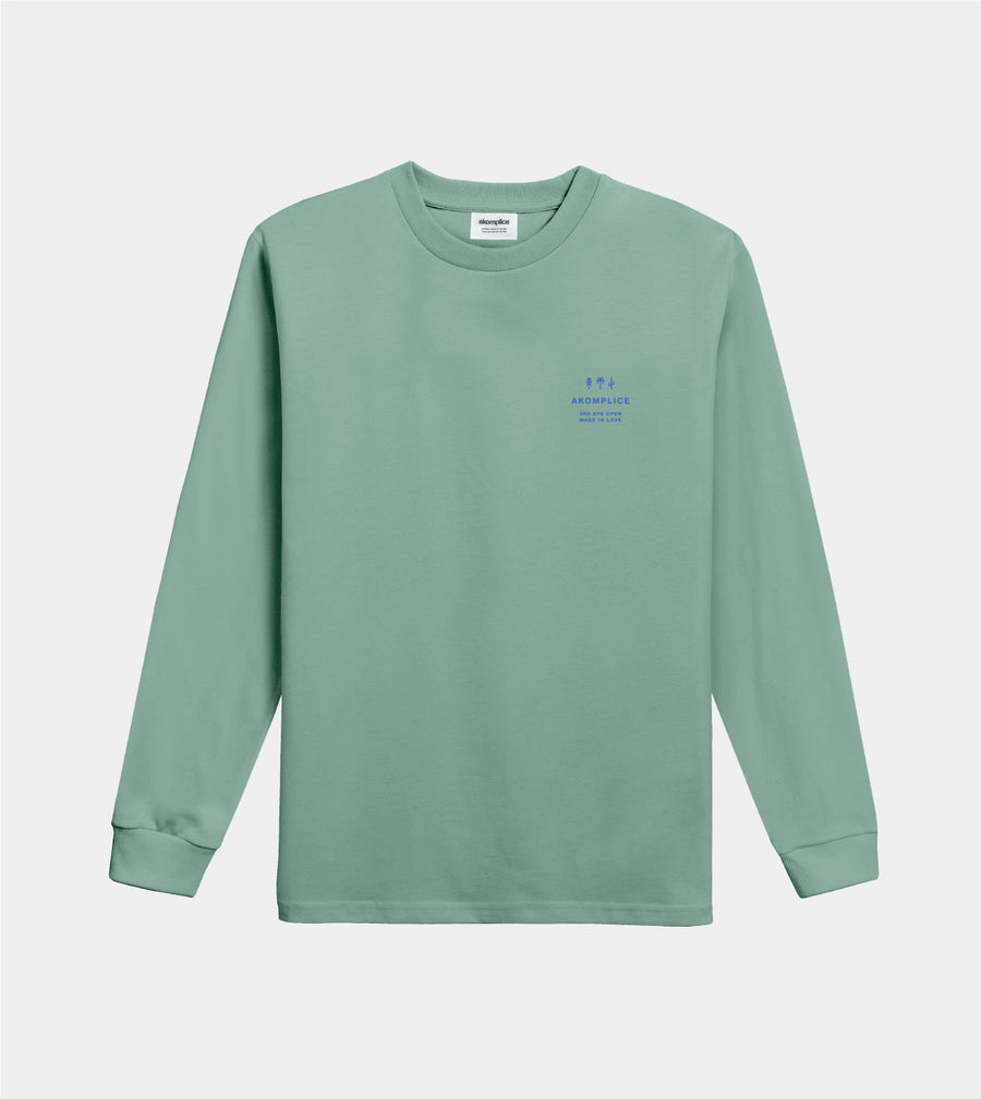 Green long-sleeve shirt with small text on a light gray background