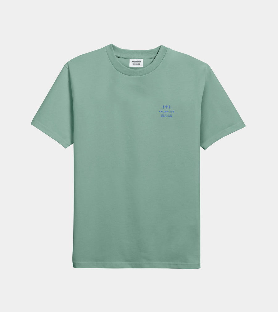 Green t-shirt with a small logo on a light gray background