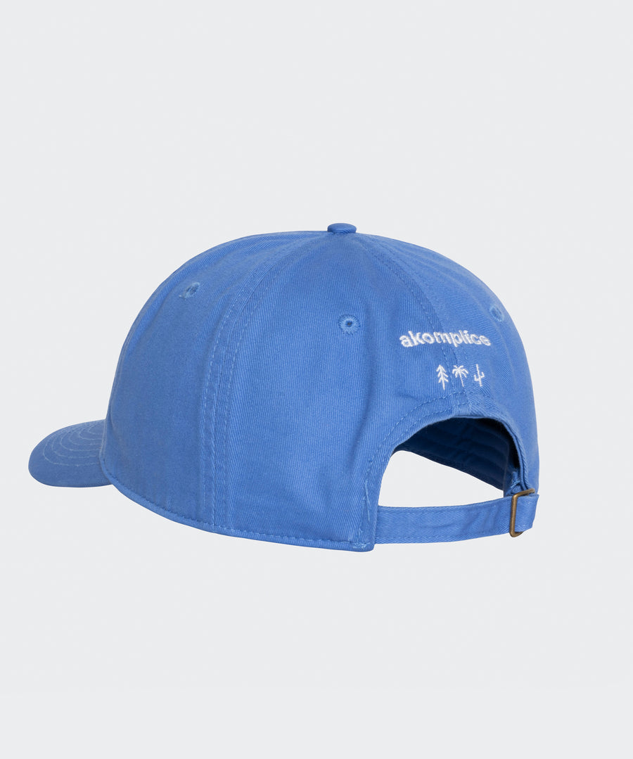 Blue cap with a brand logo on a light gray background