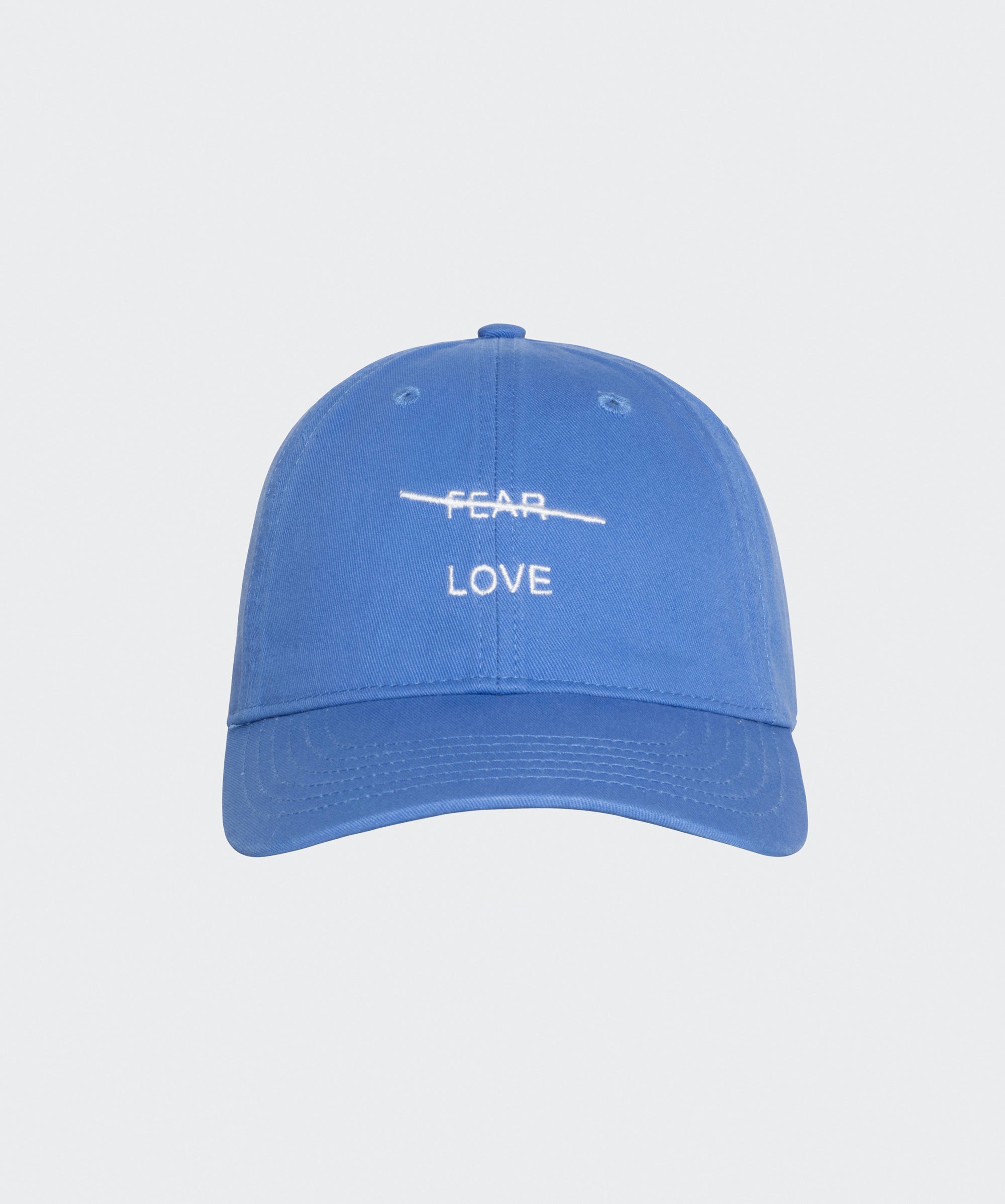 Blue cap with 'FEAR LOVE' text on a light gray background