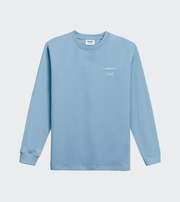 Light blue long-sleeve shirt with a small logo on a light gray background
