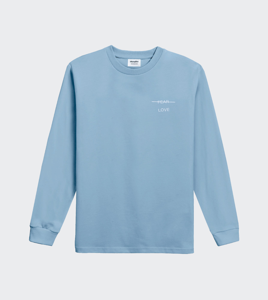 Light blue long-sleeve shirt with a small logo on a light gray background