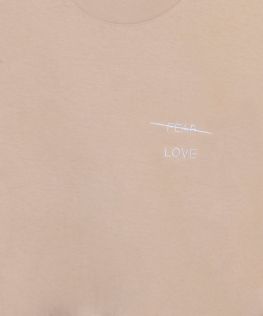 Beige fabric with 'FEAR' and 'LOVE' text on a white background