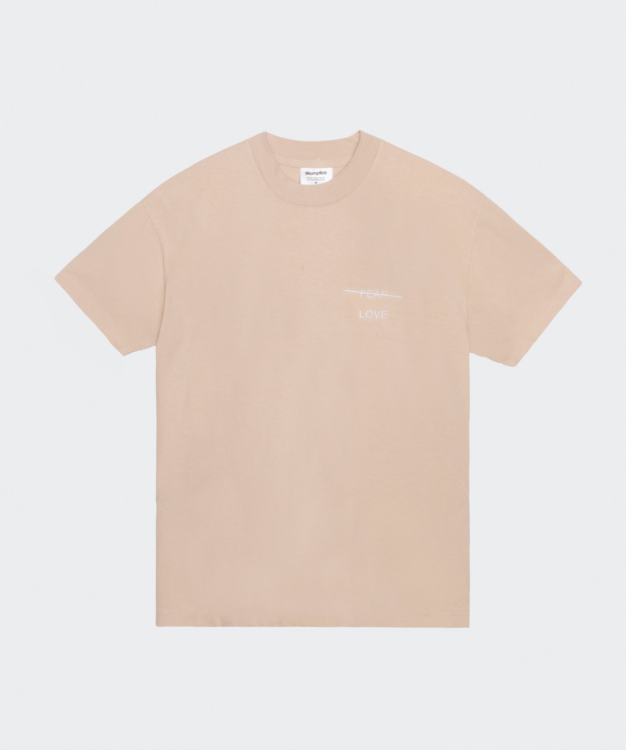 Beige t-shirt with a small logo on a white background