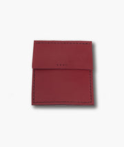 Red leather cardholder with 'VRAI' branding on a white background
