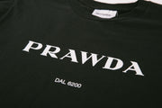 Black t-shirt with 'PRAWDA' and 'DAL 6200' text on a plain background