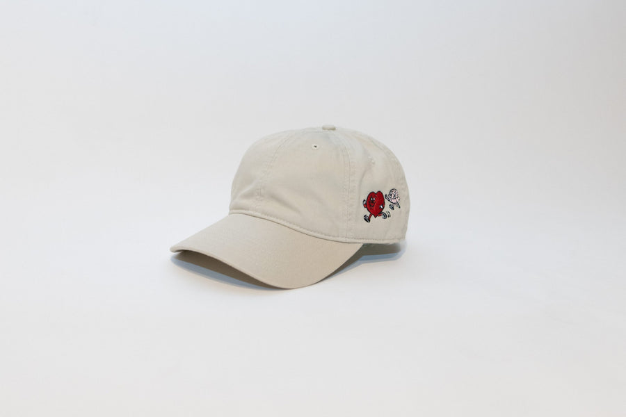 Beige cap with a small red and black design on a white background