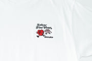 White t-shirt with a red heart graphic and text on a white background