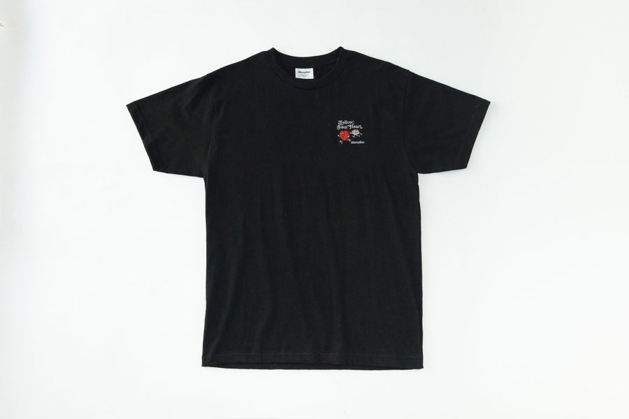 Black t-shirt with a small logo on a white background