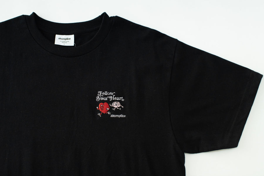 Black t-shirt with a small graphic and text on a white background