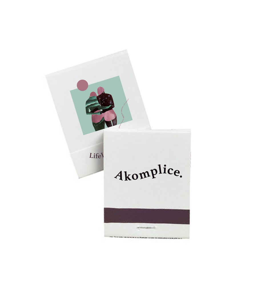 Two folded paper products with 'Akomplice' branding on a white background
