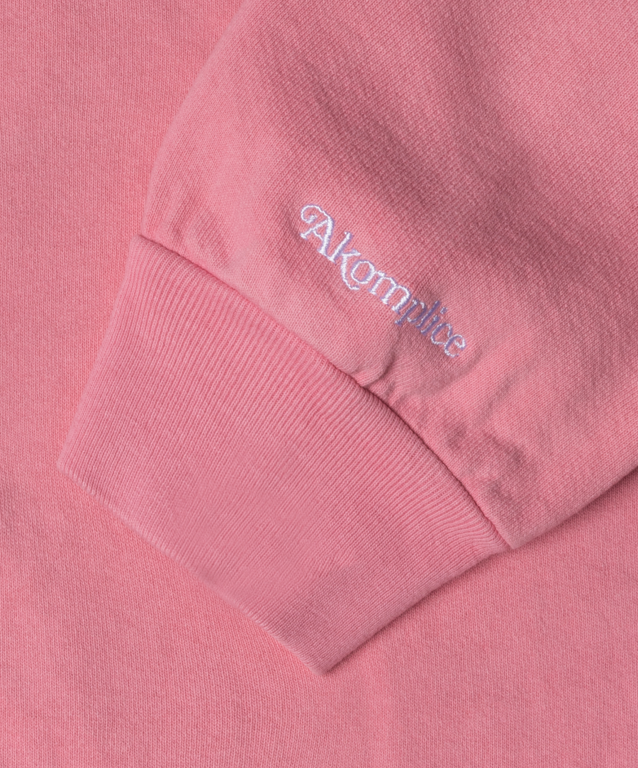 Close-up of a pink sweatshirt with 'Akgm' branding on the chest pocket.