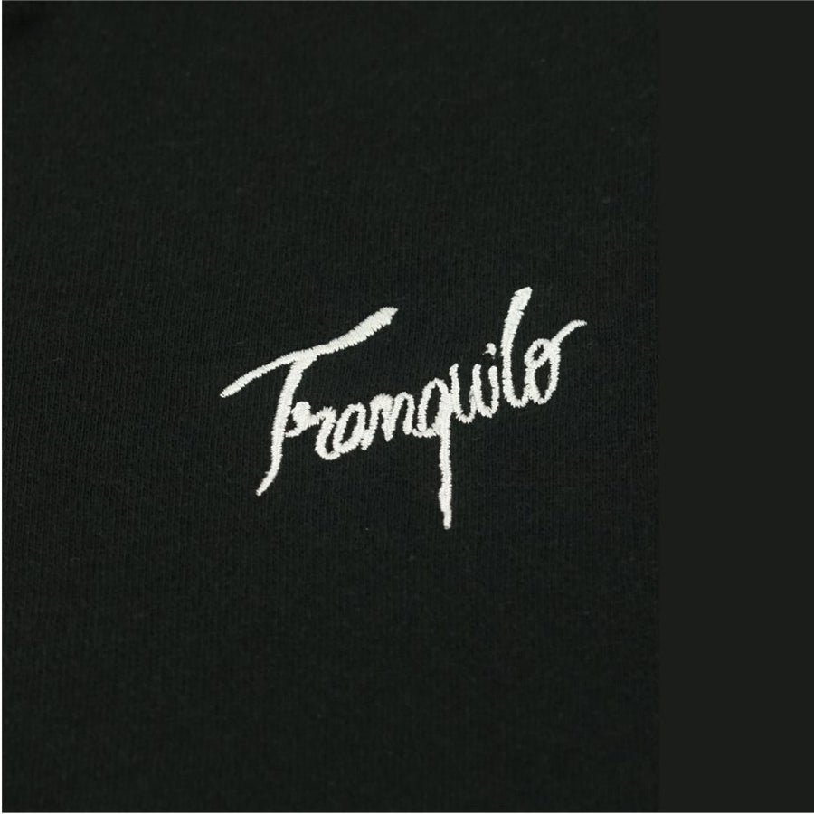White embroidered text on a black background
