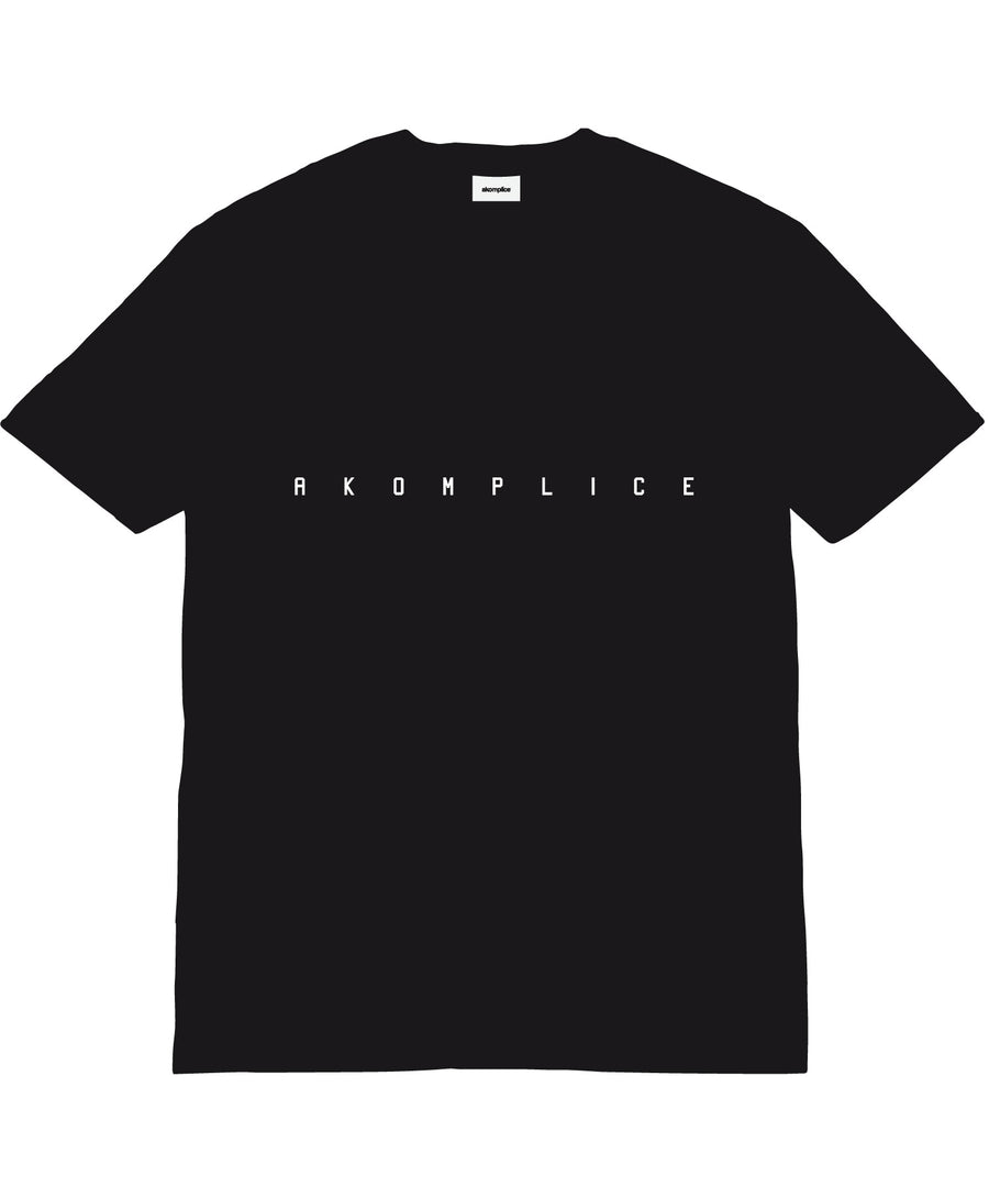 Black t-shirt with 'AKOMPLICE' text on a white background