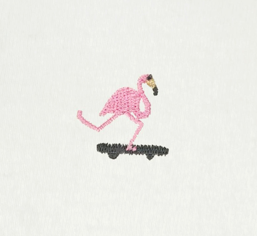 Embroidered flamingo design on a white fabric background