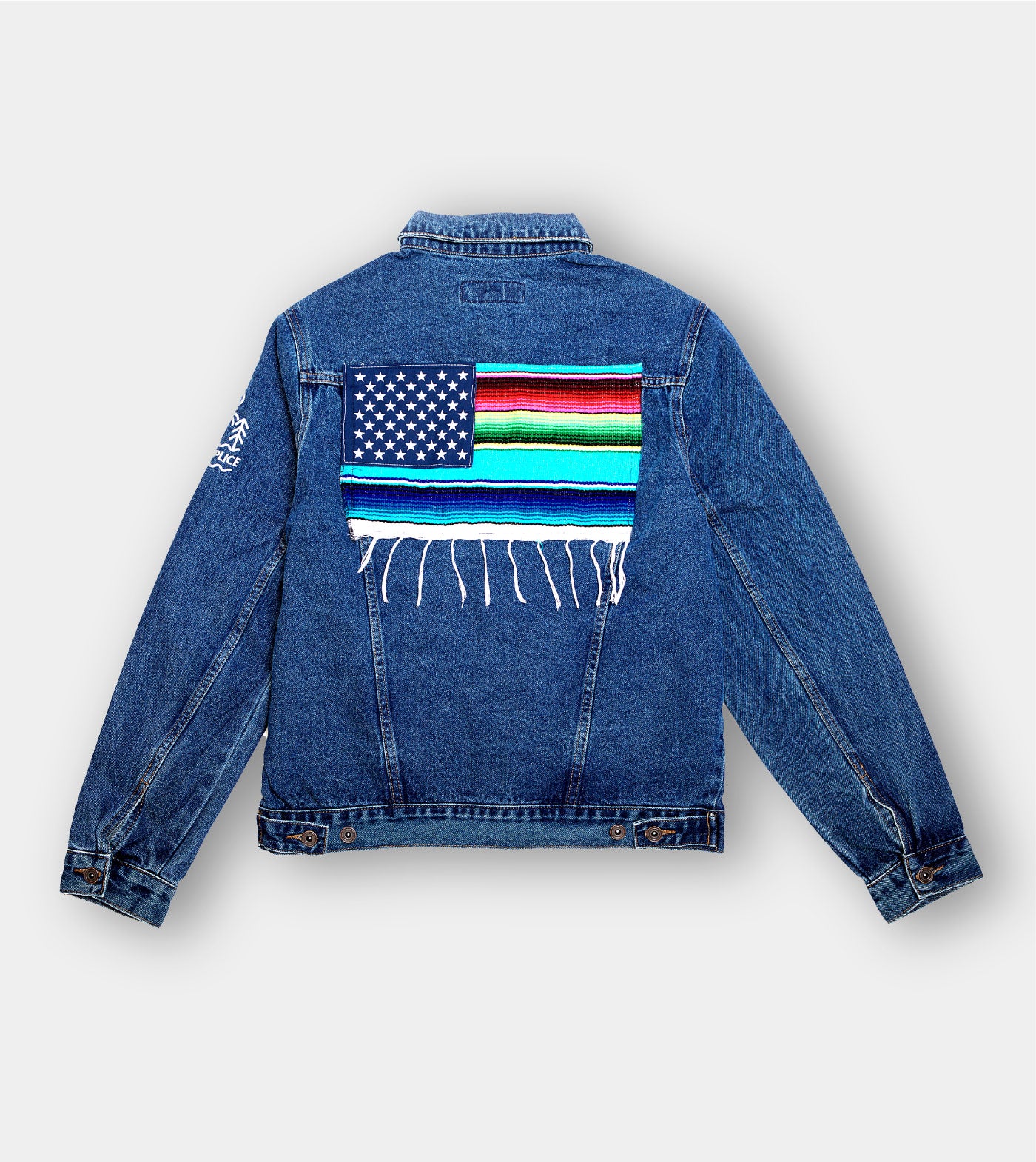 Blue denim jacket with American flag and colorful fringed design on the back against a white background