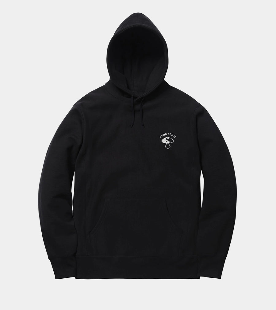 Black hoodie with a small white logo on a light gray background