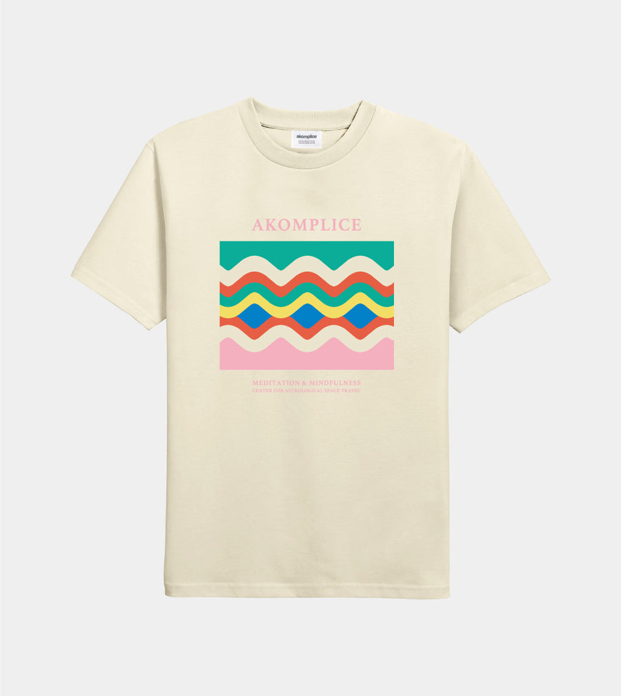Beige t-shirt with colorful wave design and 'AKOMPLICE' text on a white background